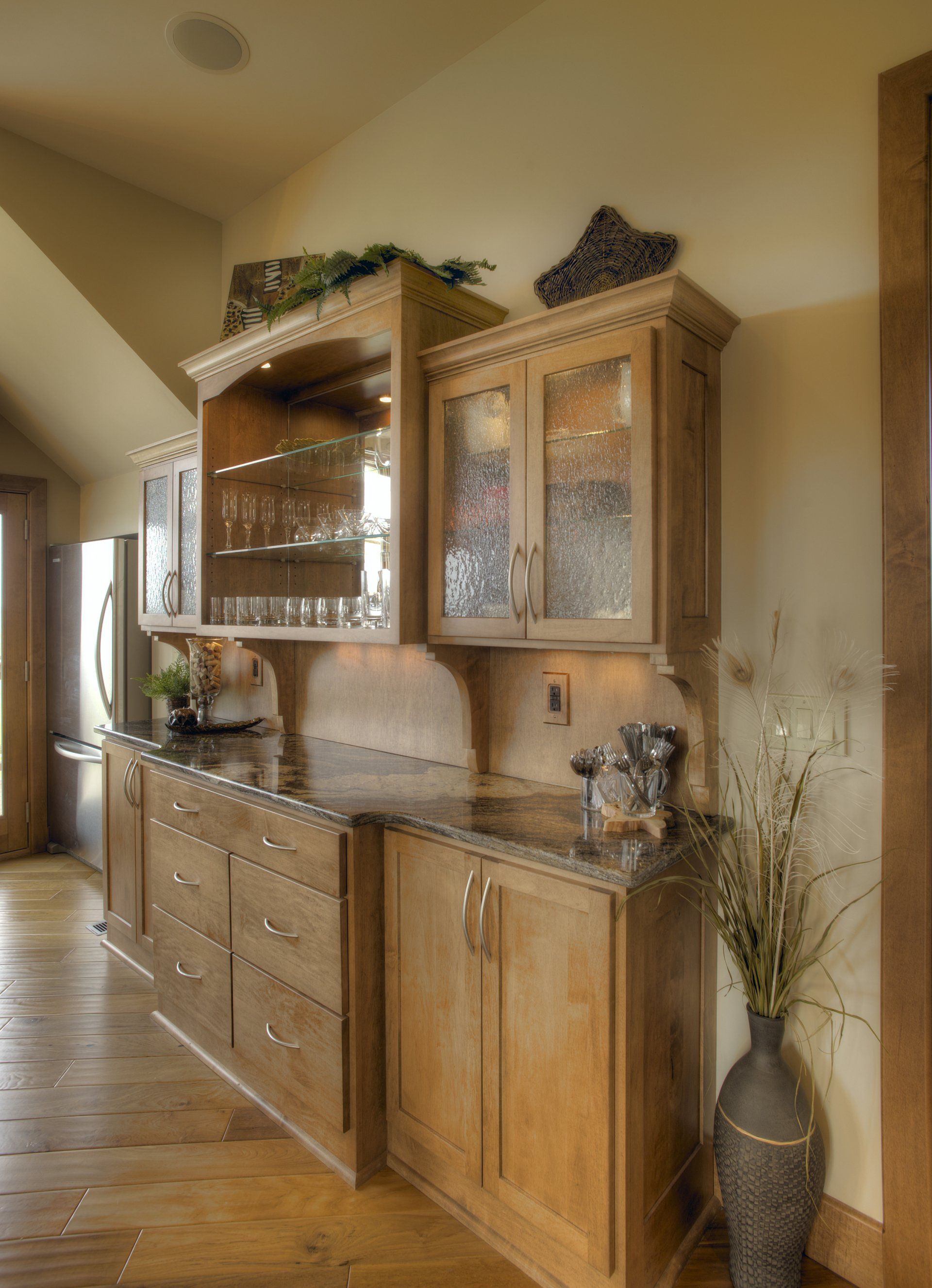 A kitchen with wooden cabinets and granite counter tops.