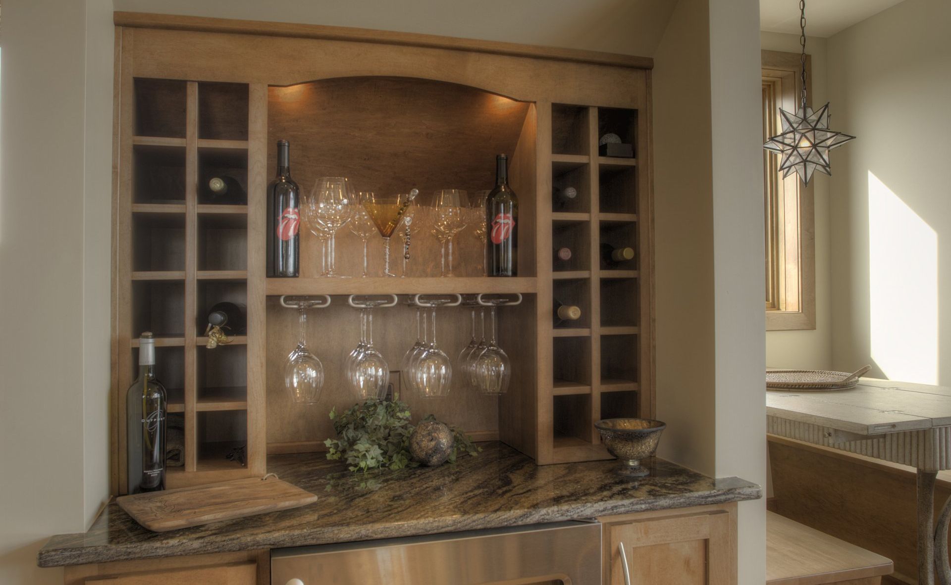 A wine rack with wine bottles and glasses on it