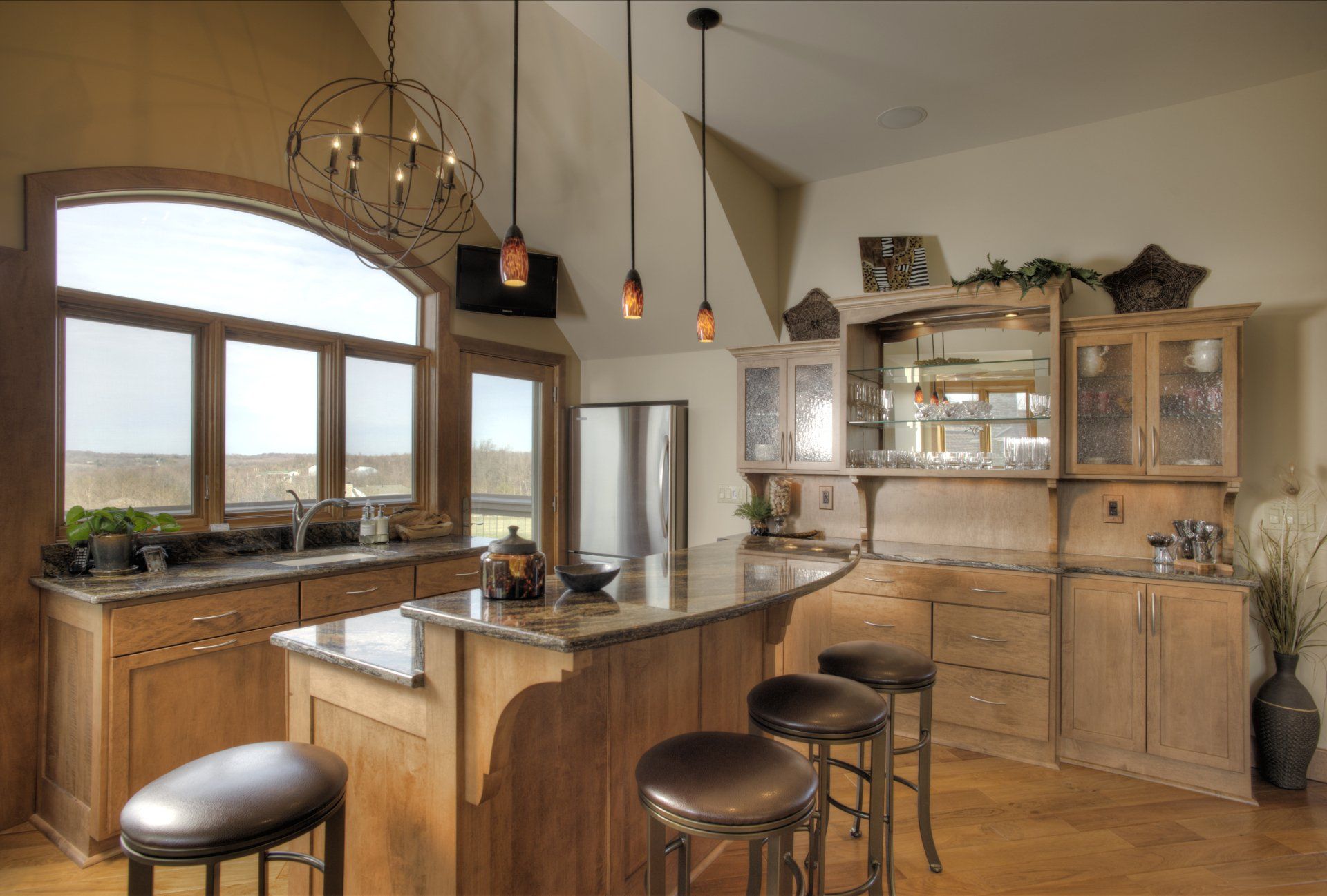 A kitchen with a large island and stools.