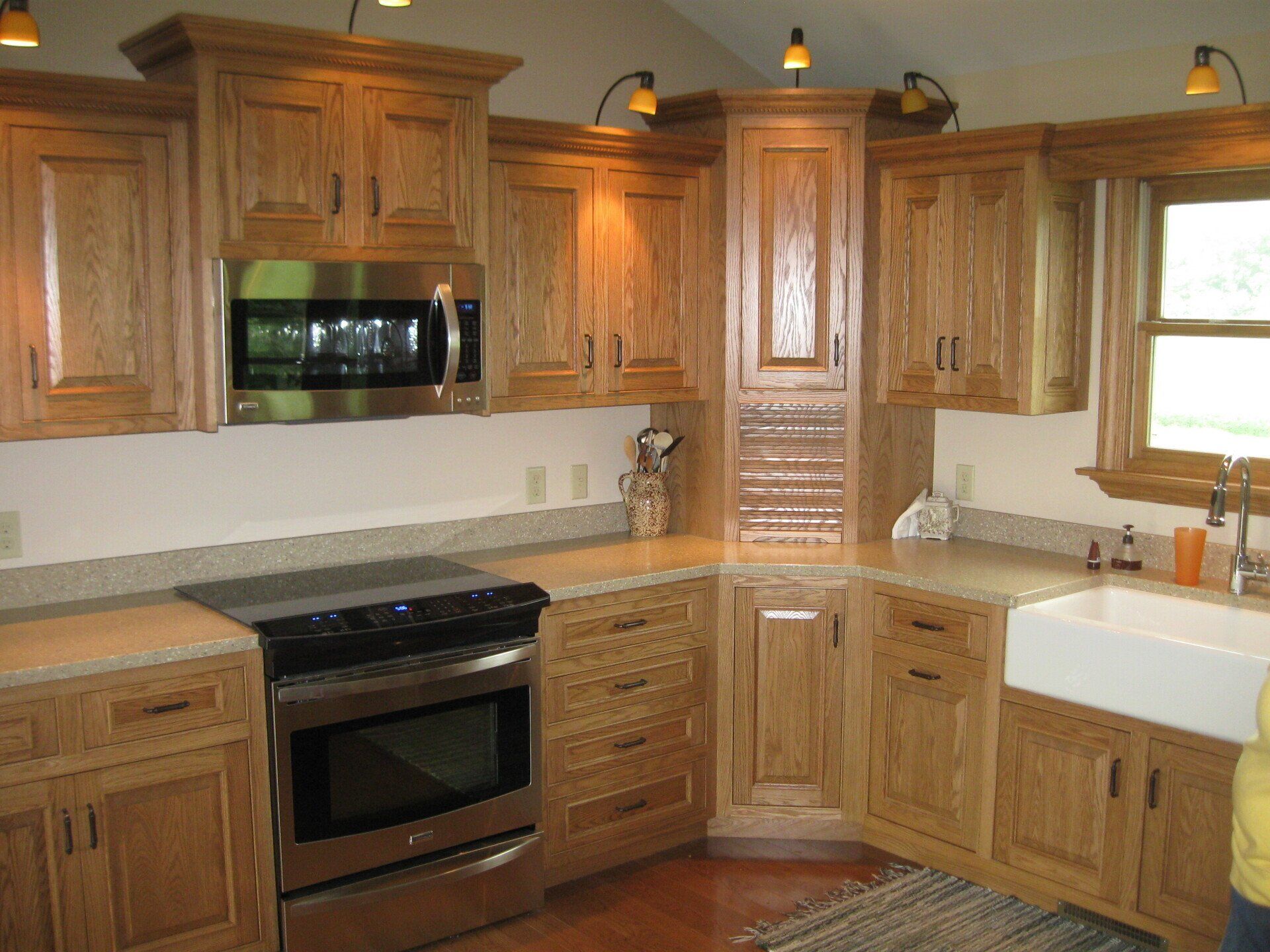 A kitchen with wooden cabinets and stainless steel appliances.
