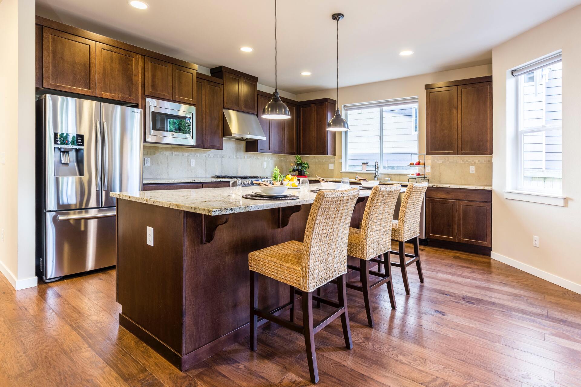 A kitchen with stainless steel appliances and wooden cabinets.