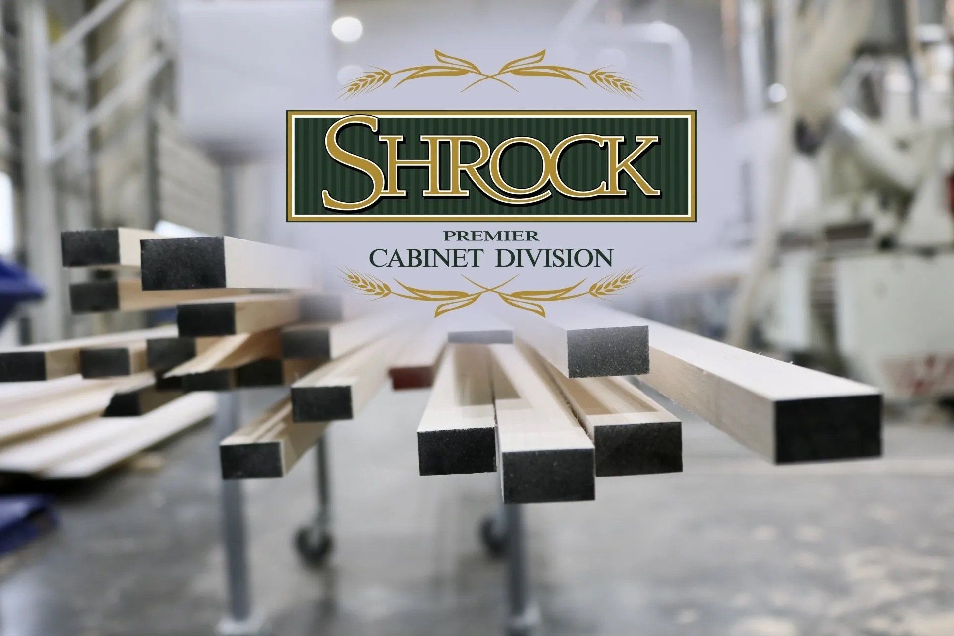 A bunch of pieces of wood are stacked on top of each other with a Shrock logo in the background.