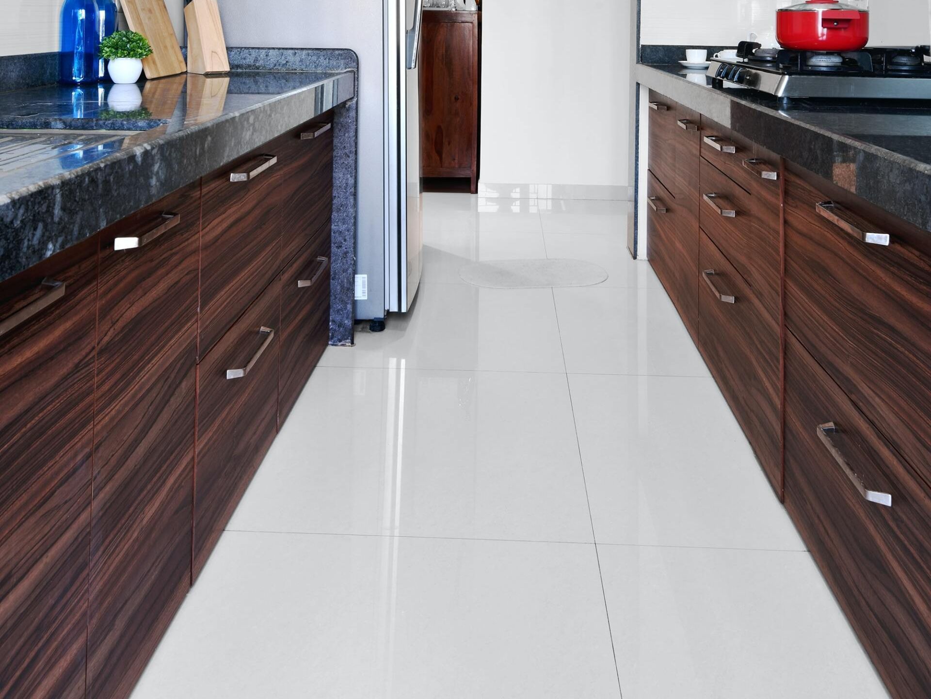 A kitchen with wooden cabinets and black counter tops.