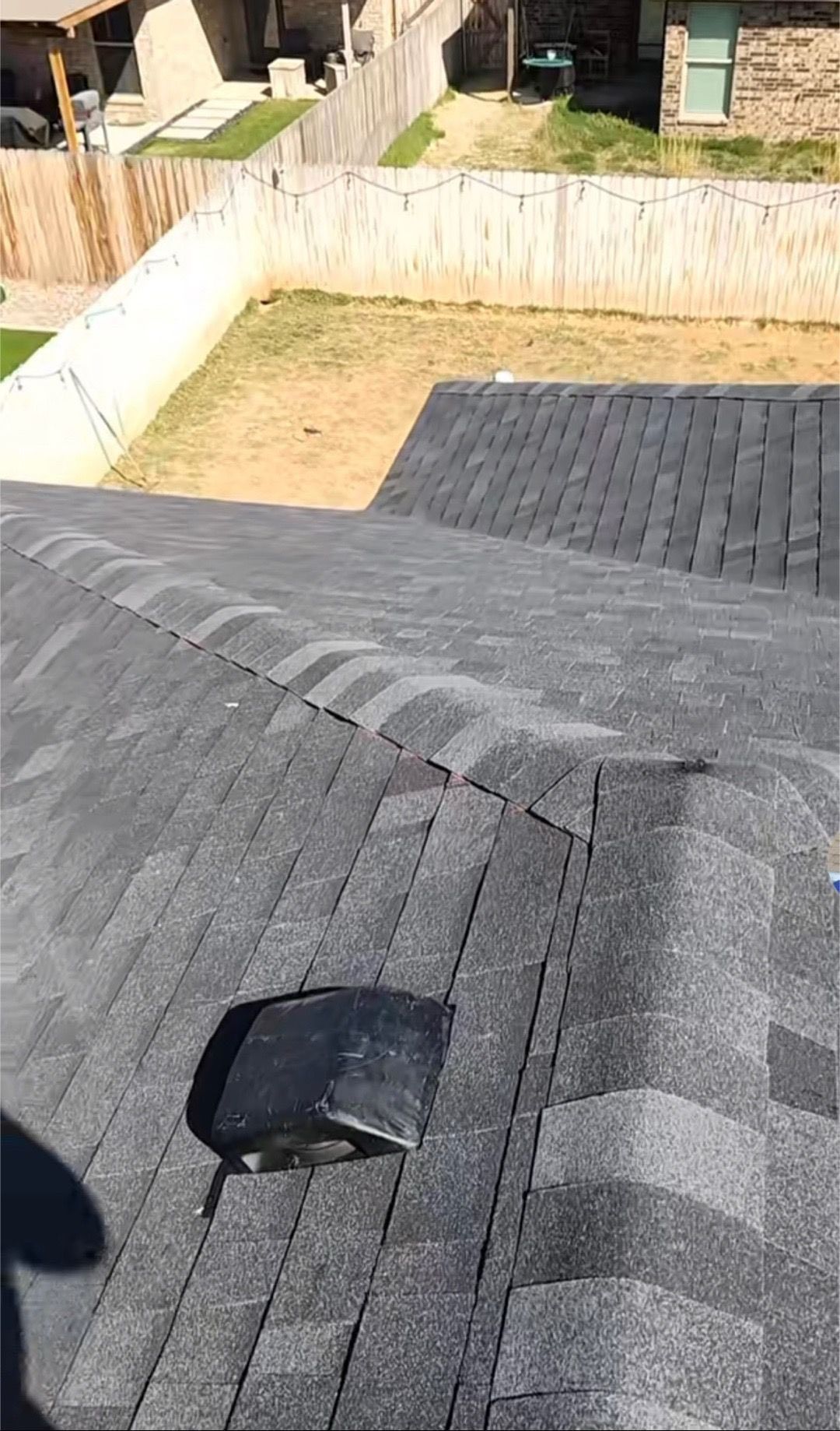 A person standing on a rooftop covered in Rhino Roof underlayment.