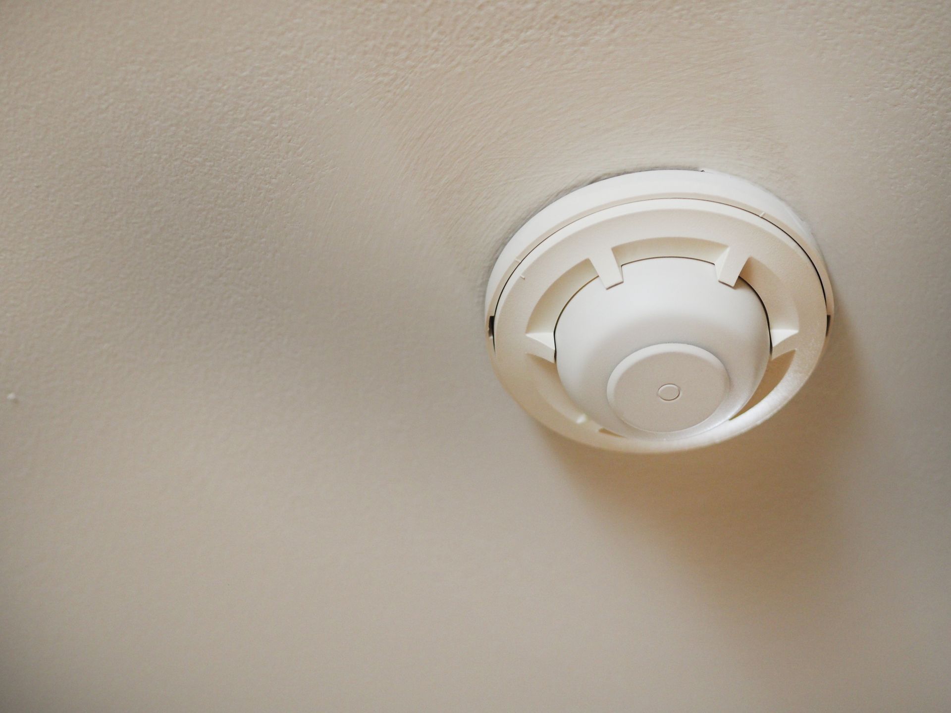 Ceiling-mounted smoke detector in home for residential fire protection services and safety. Ceiling-mounted smoke detector in home for residential fire protection services and safety.