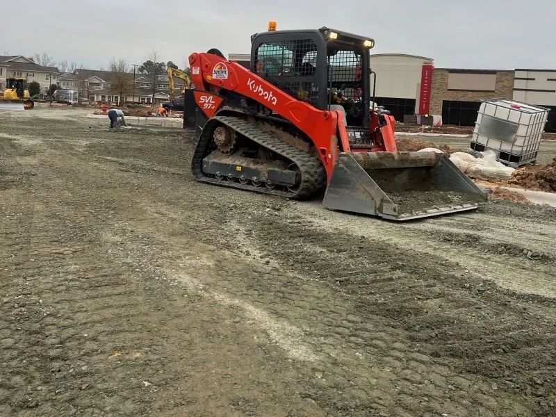 A bulldozer is moving dirt in a construction site.