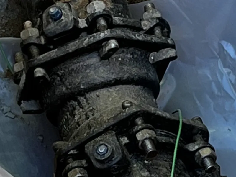 A close up of a rusty pipe in a plastic bag.