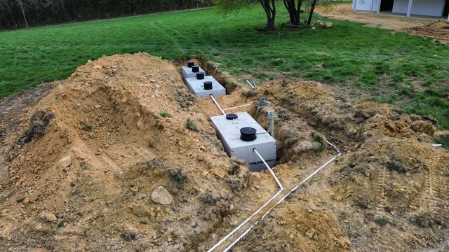 A septic system is being installed in a backyard.
