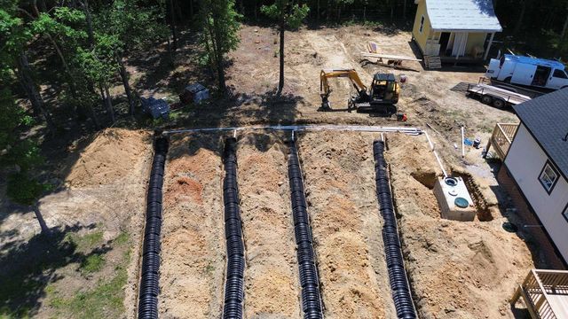 An aerial view of a septic system being installed in a yard.