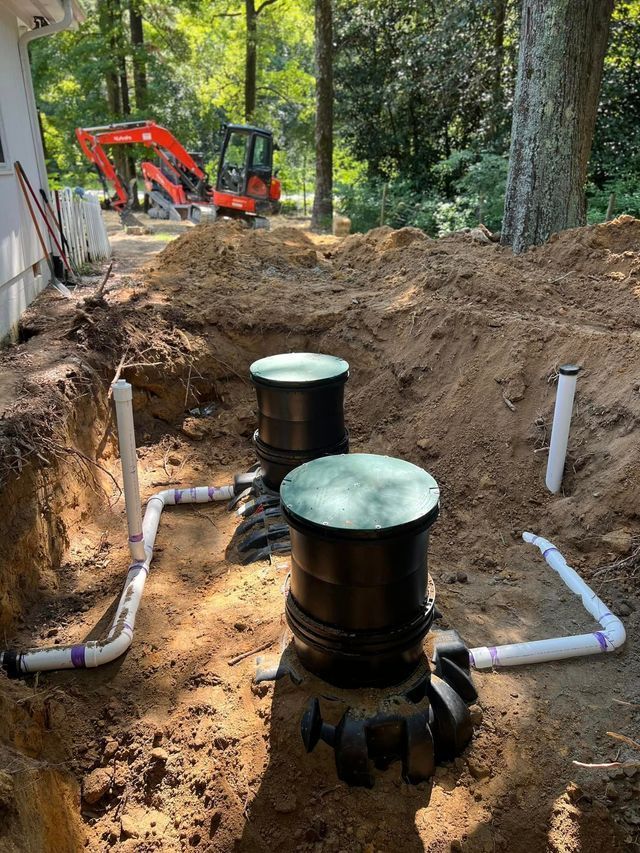 A septic system is being installed in the backyard of a house.