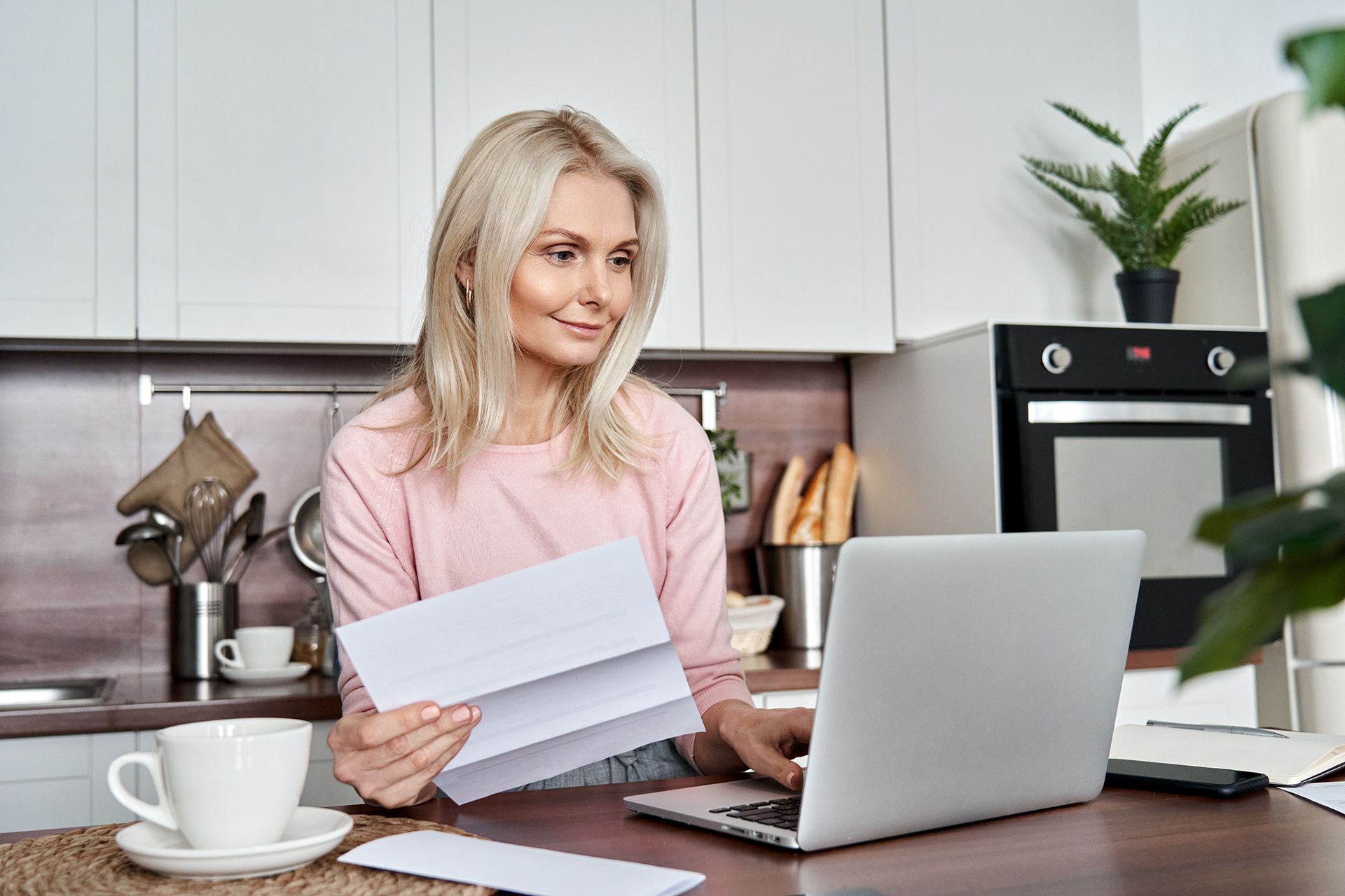 Matured Woman Checking Her Loan on Laptop