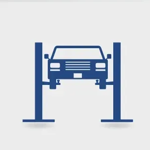 Blue car on a lift in a garage.