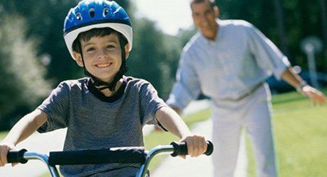 Boy cycling with his father - Divorce Attorney Services in Worcester, MA