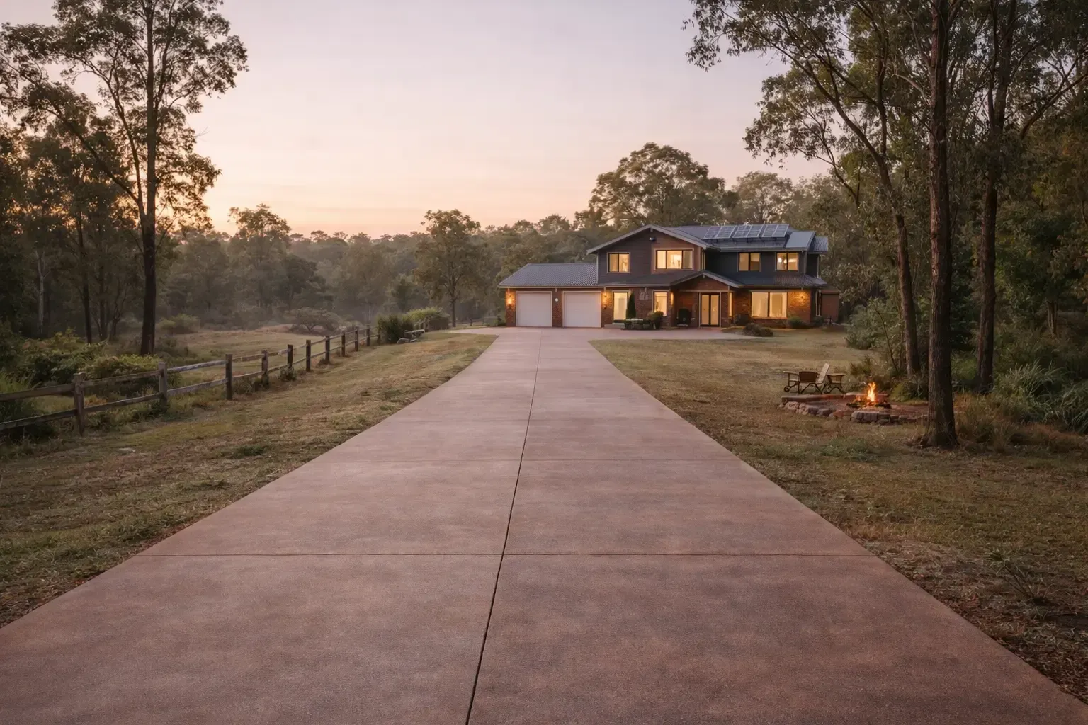 A two-story house at the end of a long coloured concrete driveway, on a rural property near Linthorpe, Toowoomba