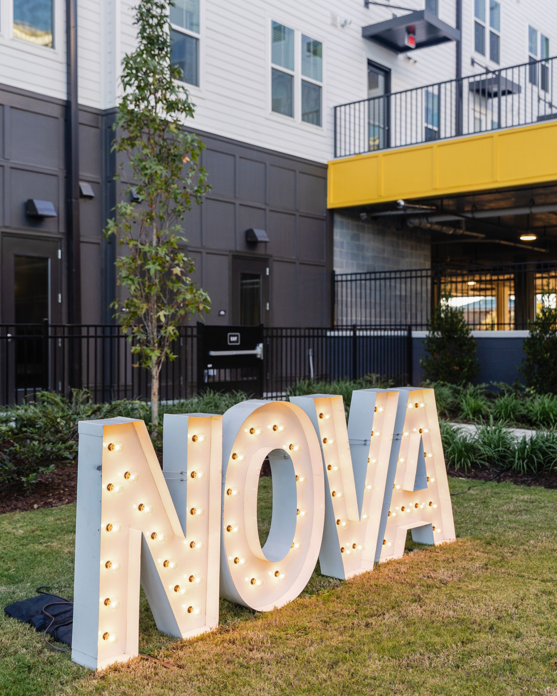 A group of women are sitting on yoga mats in a gym.