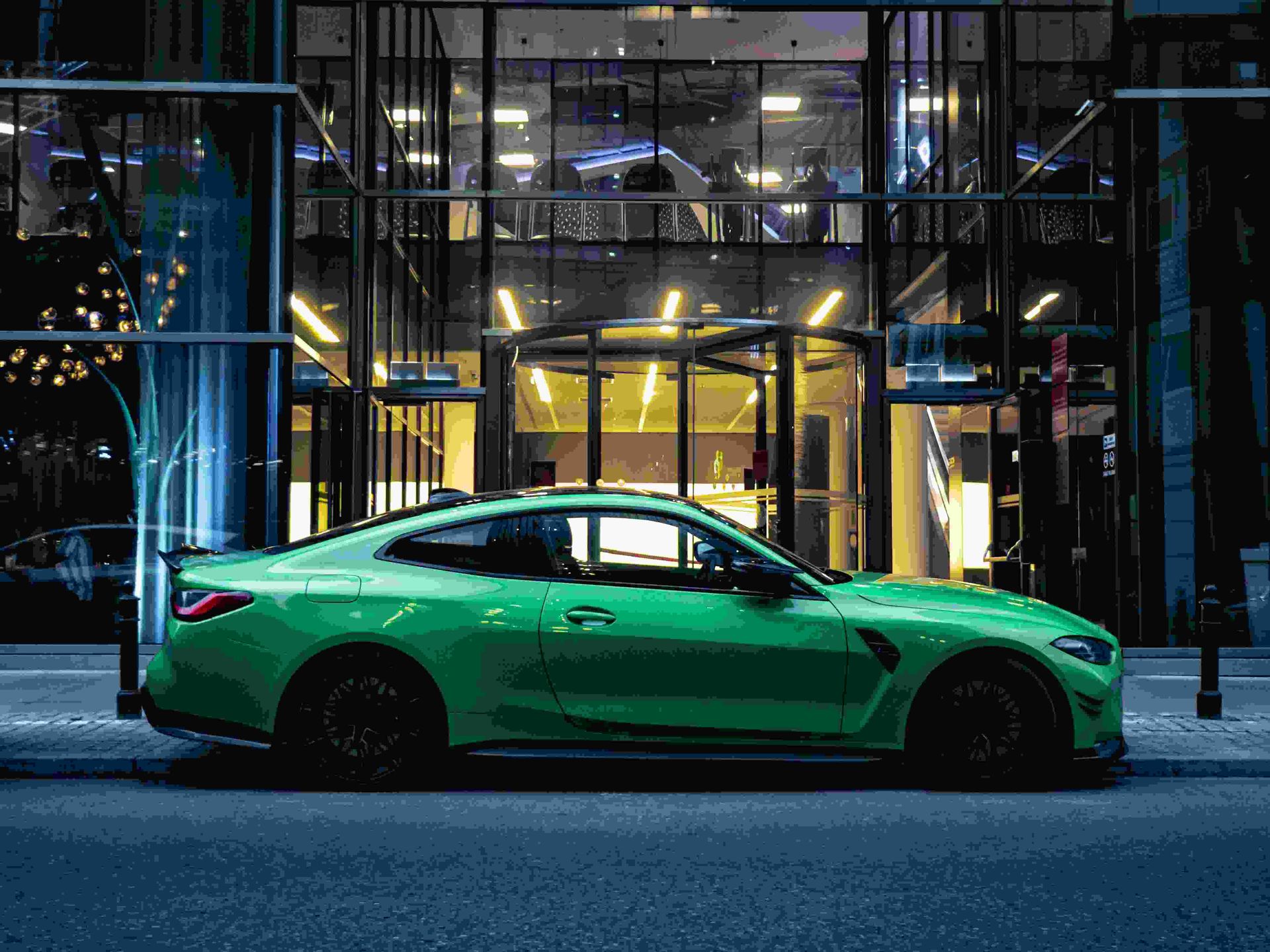 A Green Bmw M4 Is Parked On The Side Of The Road In Front Of A Building — JA Toft & Co In Bundaberg Central, QLD