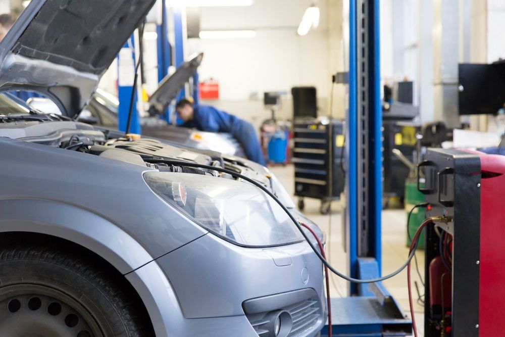 A Car Is Being Repaired In A Garage With The Hood Up — JA Toft & Co In Bundaberg Central, QLD
