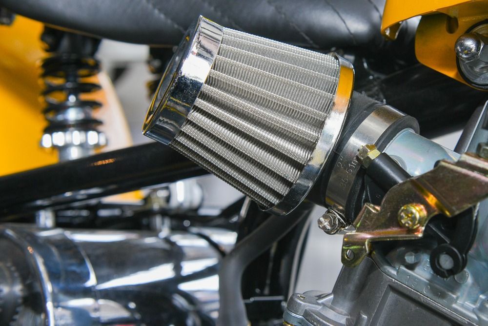 A Close Up Of A Motorcycle Engine With A Filter Attached To It — JA Toft & Co In Bundaberg Central, QLD