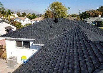 Roofing Maintenance — House roof with chimney in San Dimas, CA