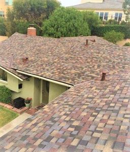 Roofing — Man drilling on the roof in San Dimas, CA