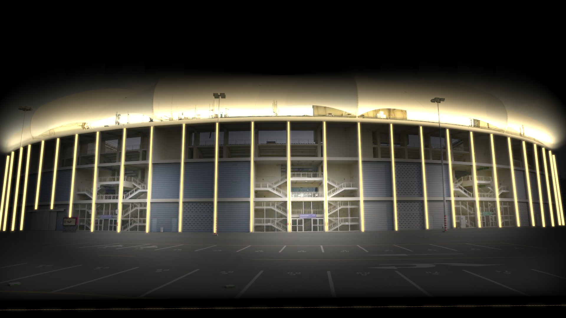 Nachtansicht eines Stadions mit hellen Lichtern, die das Gebäude erhellen.