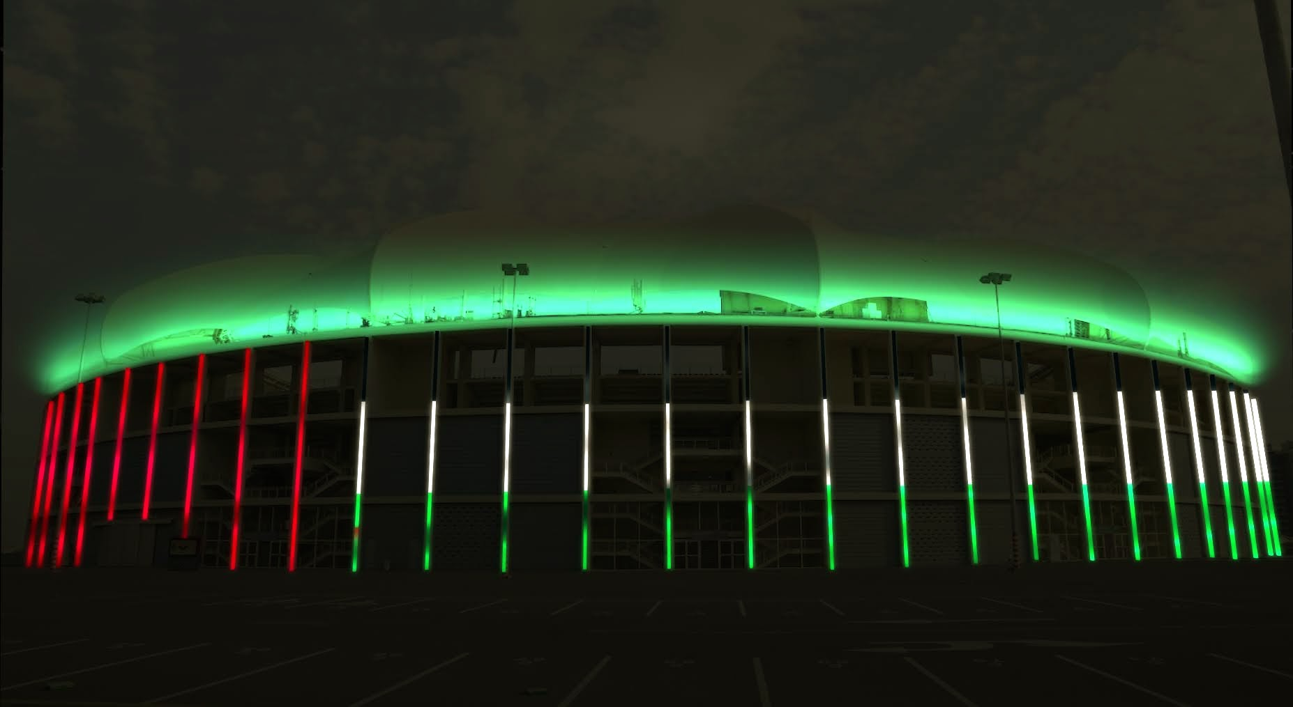 Das Stadion ist nachts mit grünen, weißen und roten Lichtern beleuchtet, wahrscheinlich zur Feier einer Veranstaltung oder eines Nationalfeiertags.