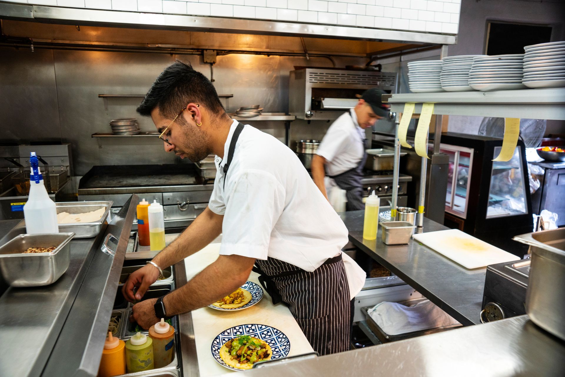 A Man is Preparing Food in a Restaurant Kitchen — Island Heights, NJ — Air We Are Heating, Cooling, & Refrigeration