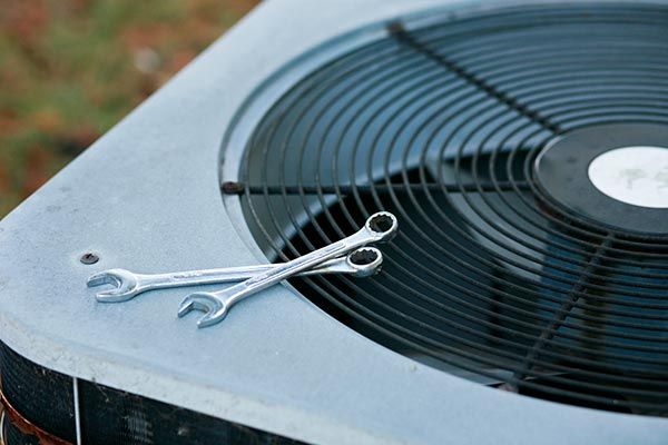 Air Conditioner Being Fixed — Island Heights, NJ — Air We Are Heating, Cooling, & Refrigeration