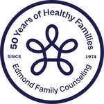 The logo for edmond family counseling shows a flower in a circle.