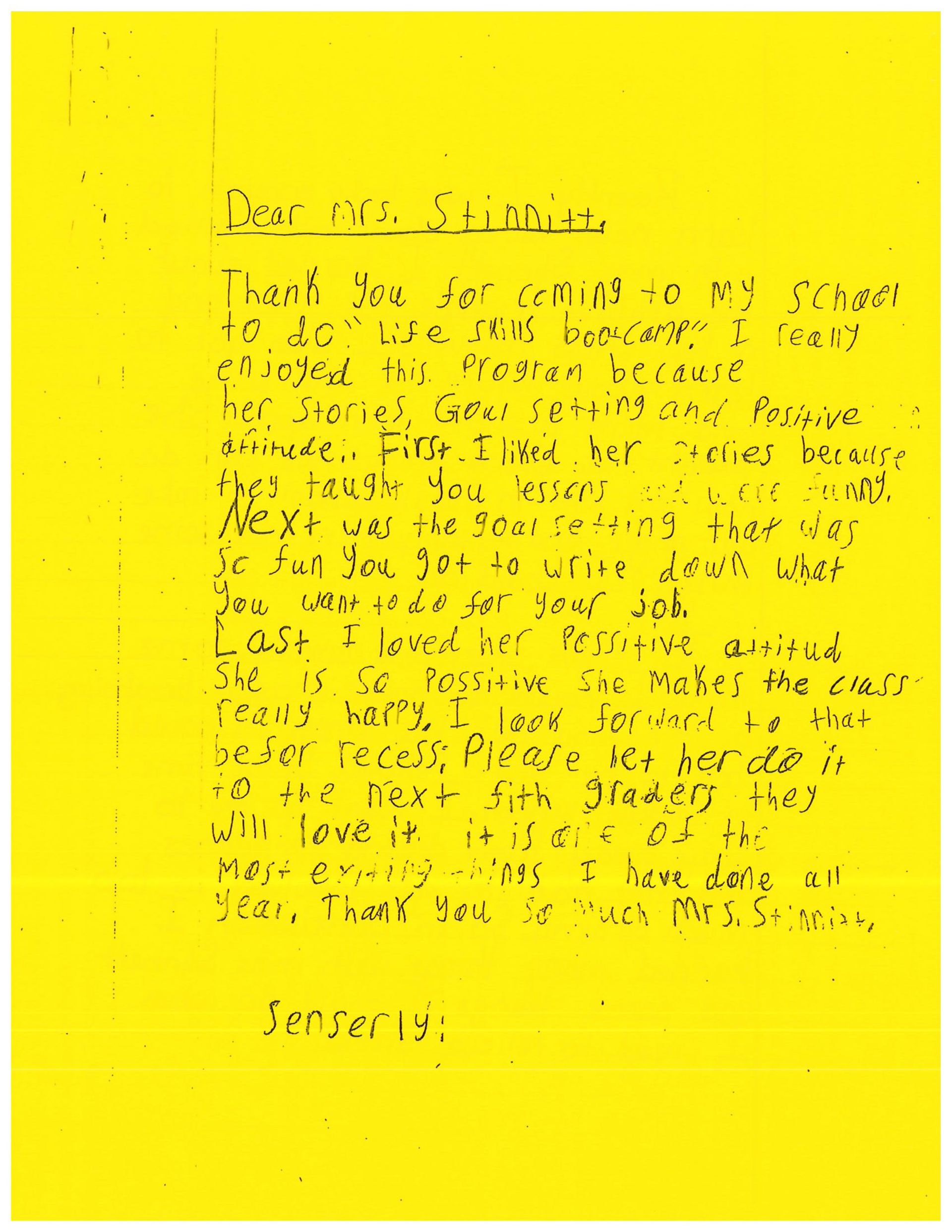 A yellow piece of paper with black writing on it