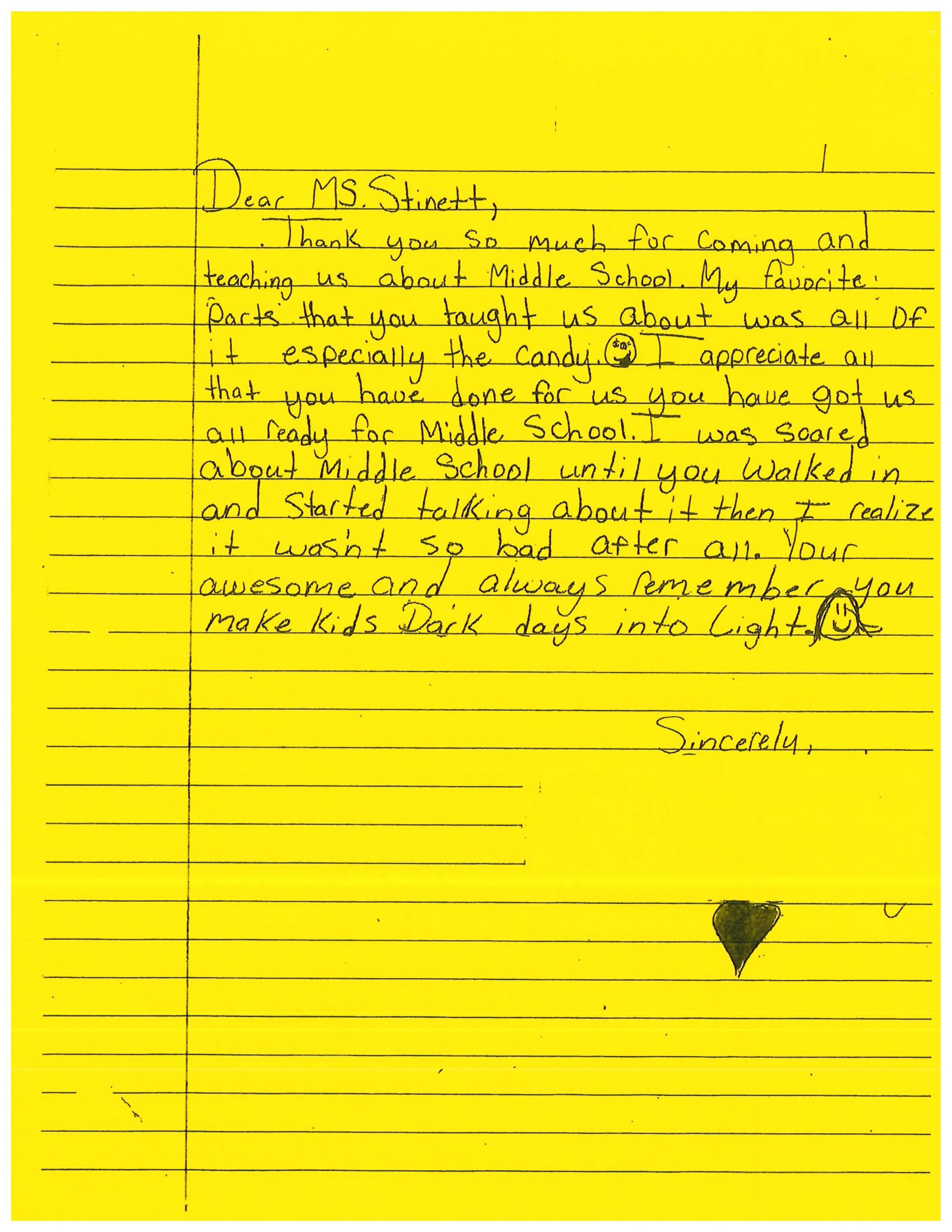 A yellow piece of paper with black writing on it