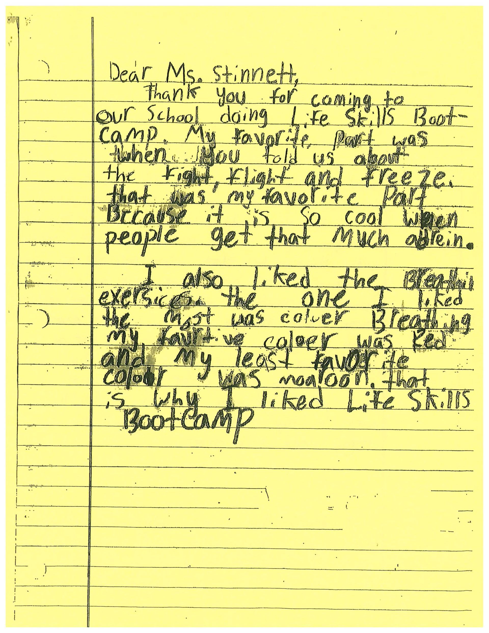 A letter is written on a piece of yellow paper