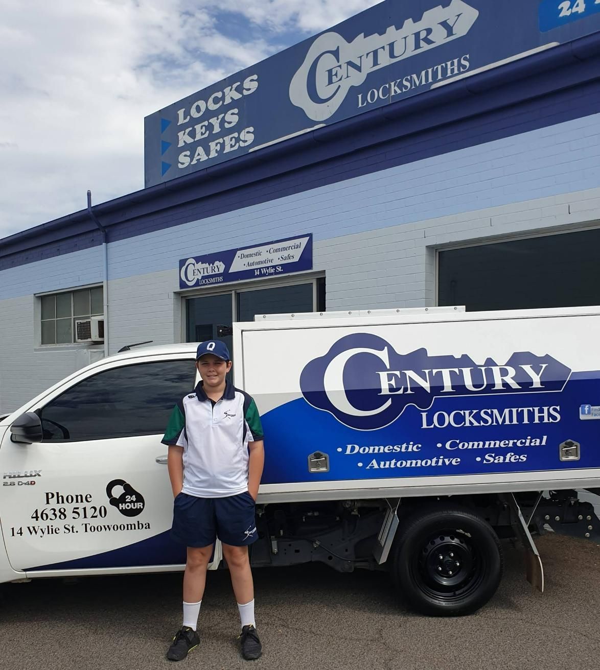 A Young Locksmith Stands by His Century Locksmiths Truck in Front of the Business — Century Locksmiths in Gatton, QLD