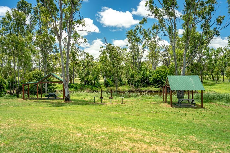 A Picnic Area with A Green Shelter in The Middle of A Grassy Field — Century Locksmiths In Crows Nest, QLD
