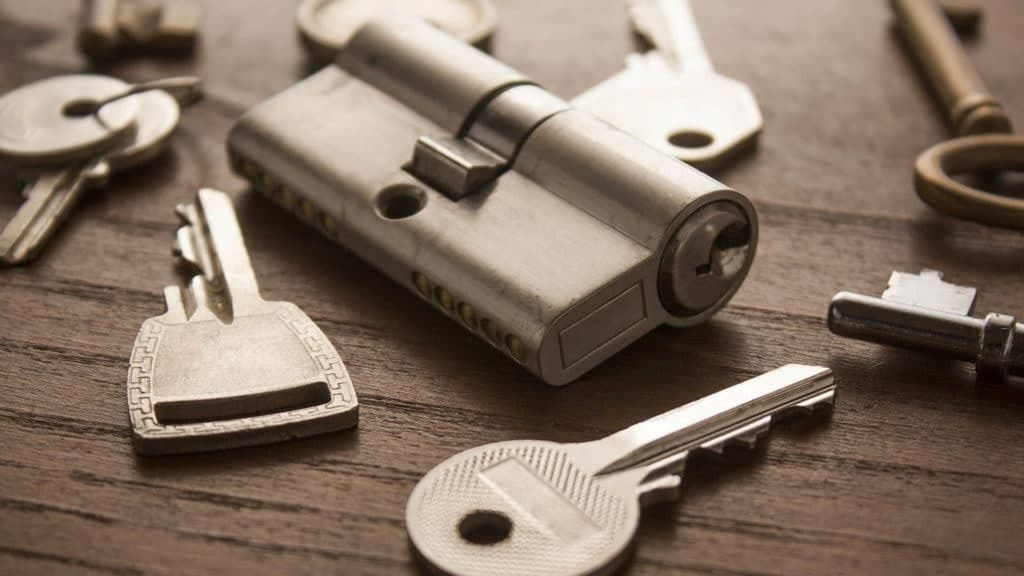 A Bunch of Keys and A Lock on A Wooden Table — Century Locksmiths In Toowoomba City, QLD