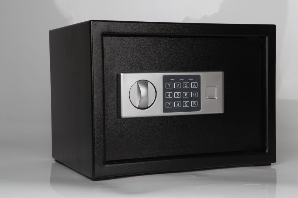 Black Digital Safe With Keypad and Handle, Against a Light Gray Background — Century Locksmiths In Dalby, QLD