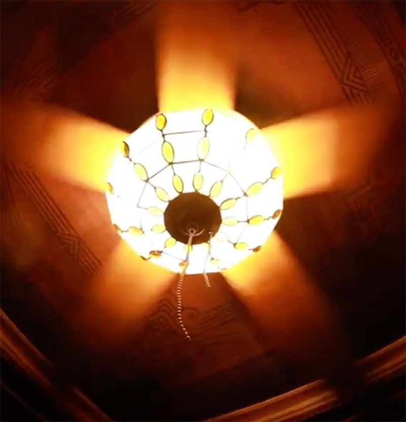 Een plafondventilator met een licht erdoorheen schijnend