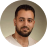 A man with a beard and a white shirt is in a circle.