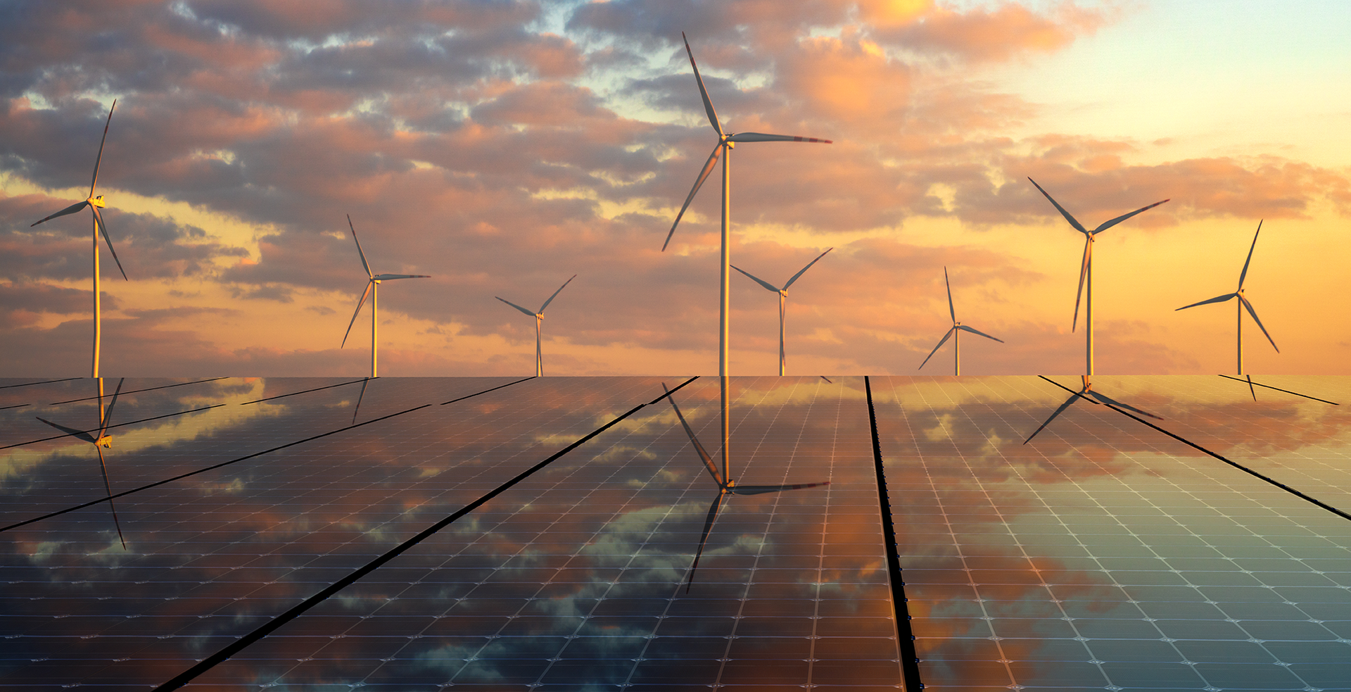 A row of wind turbines and solar panels in the ocean at sunset.