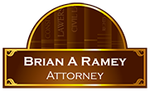A sign for brian a ramey attorney with books in the background.