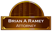 A sign for brian a ramey attorney with books in the background.