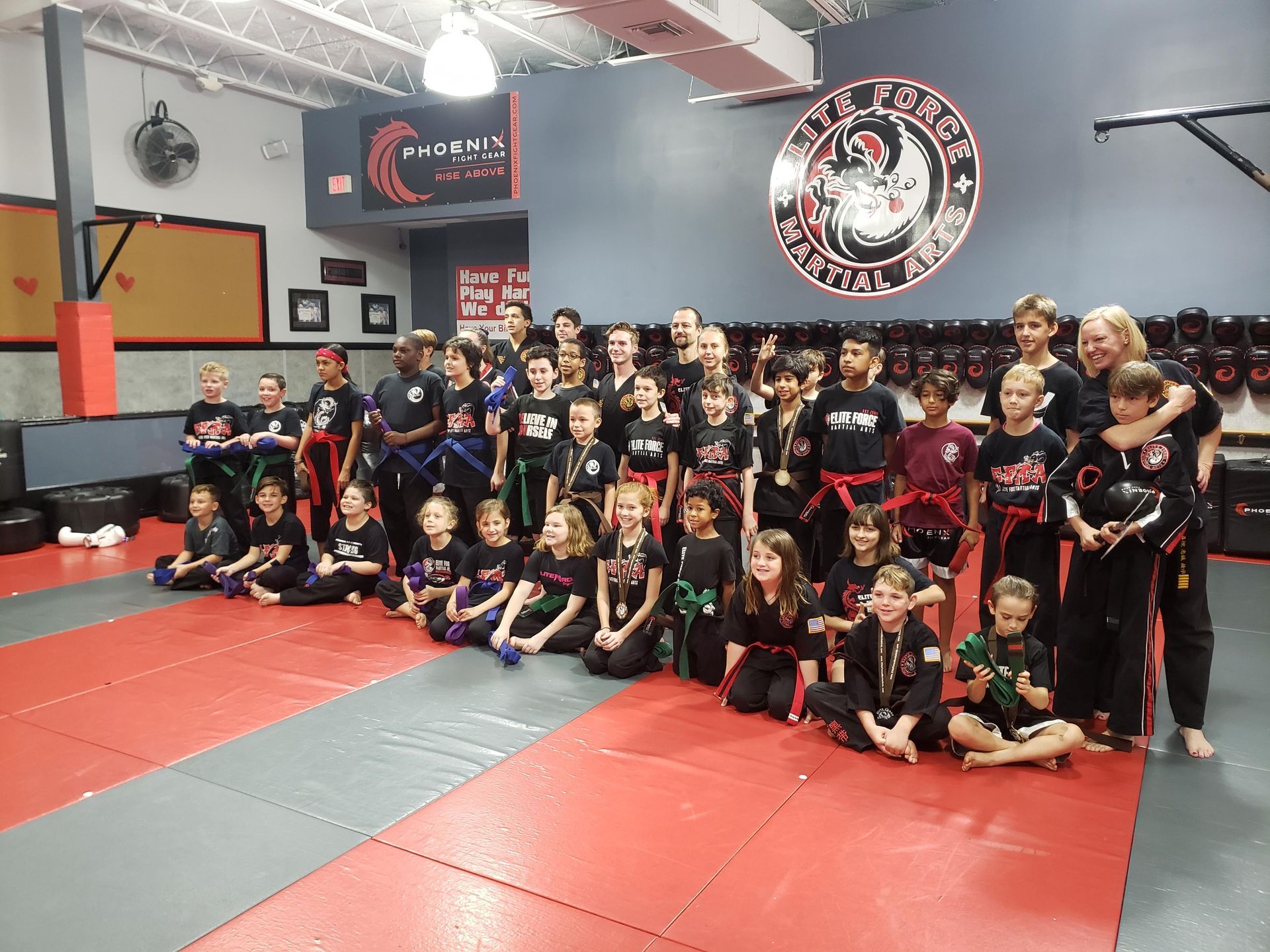 A group of children are posing for a picture in a gym.
