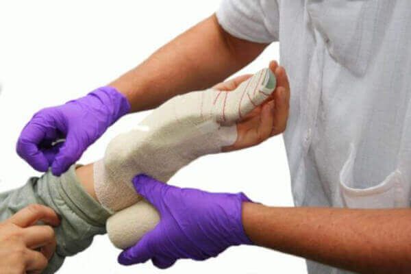 Applying a splint to a patient's hand and arm.