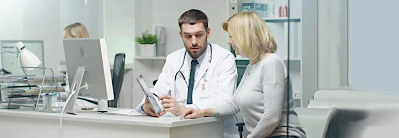 male doctor consults with a female patient