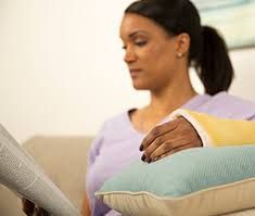 woman reading with her hand elevated