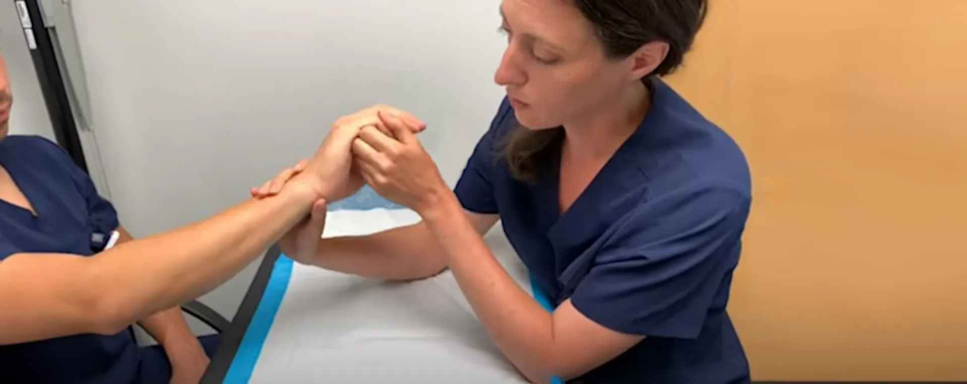 therapist examines a patent's hand