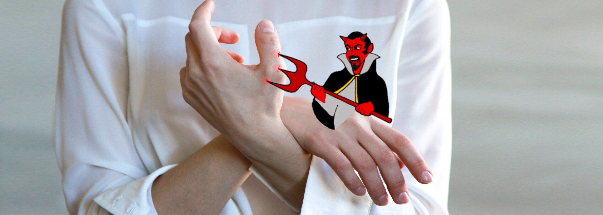 tiny demon jabbing a hand with a pitchfork