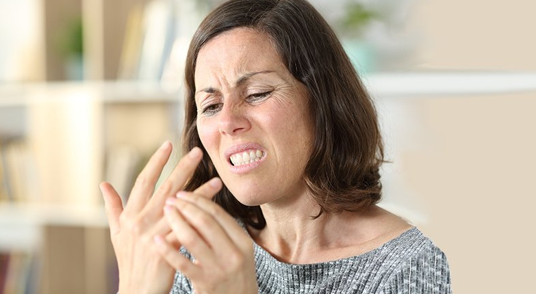 Brunette woman with intense finger numbness and pain.