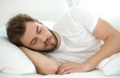 man sleeping with his hand under his head