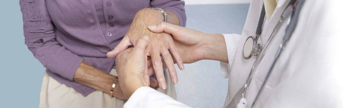 therapist examines a female patient's hand